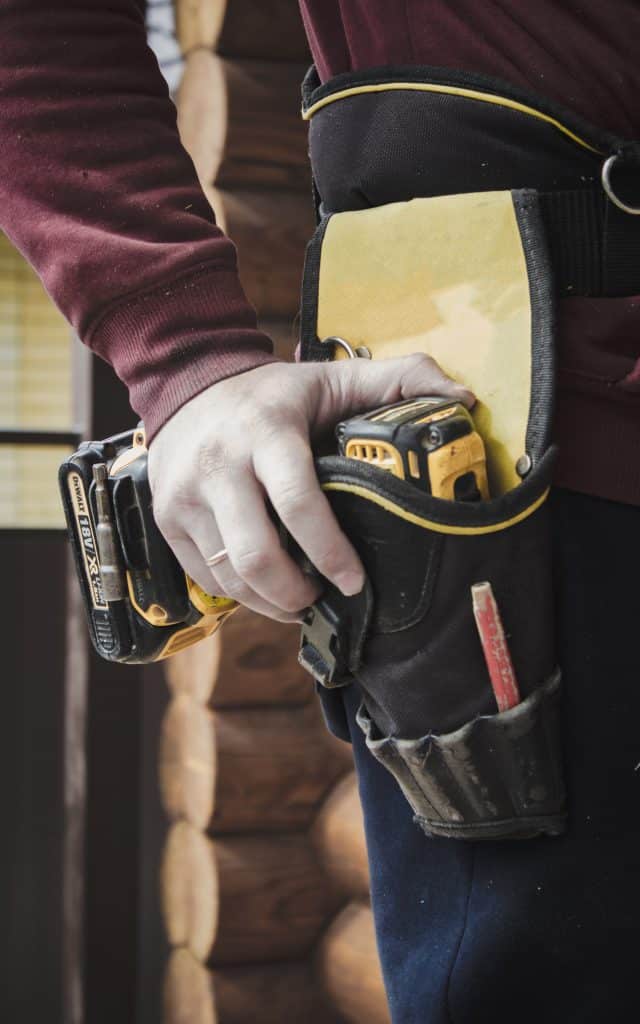 Second image highlighting an individual holding a power drill for the 24/7 emergency boarding section