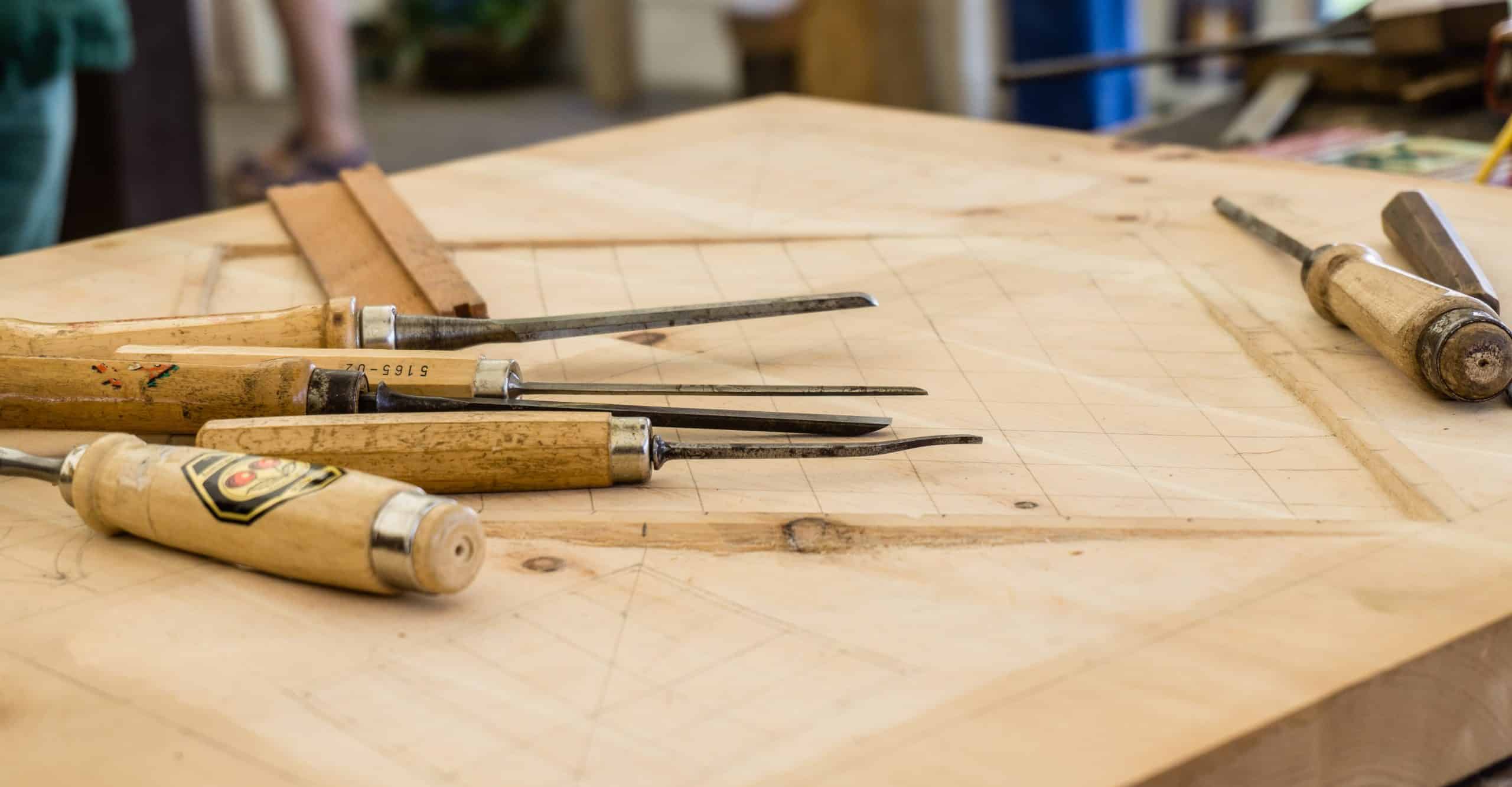 Location based call to action background image featuring construction and renovation related tools on a wooden work surface