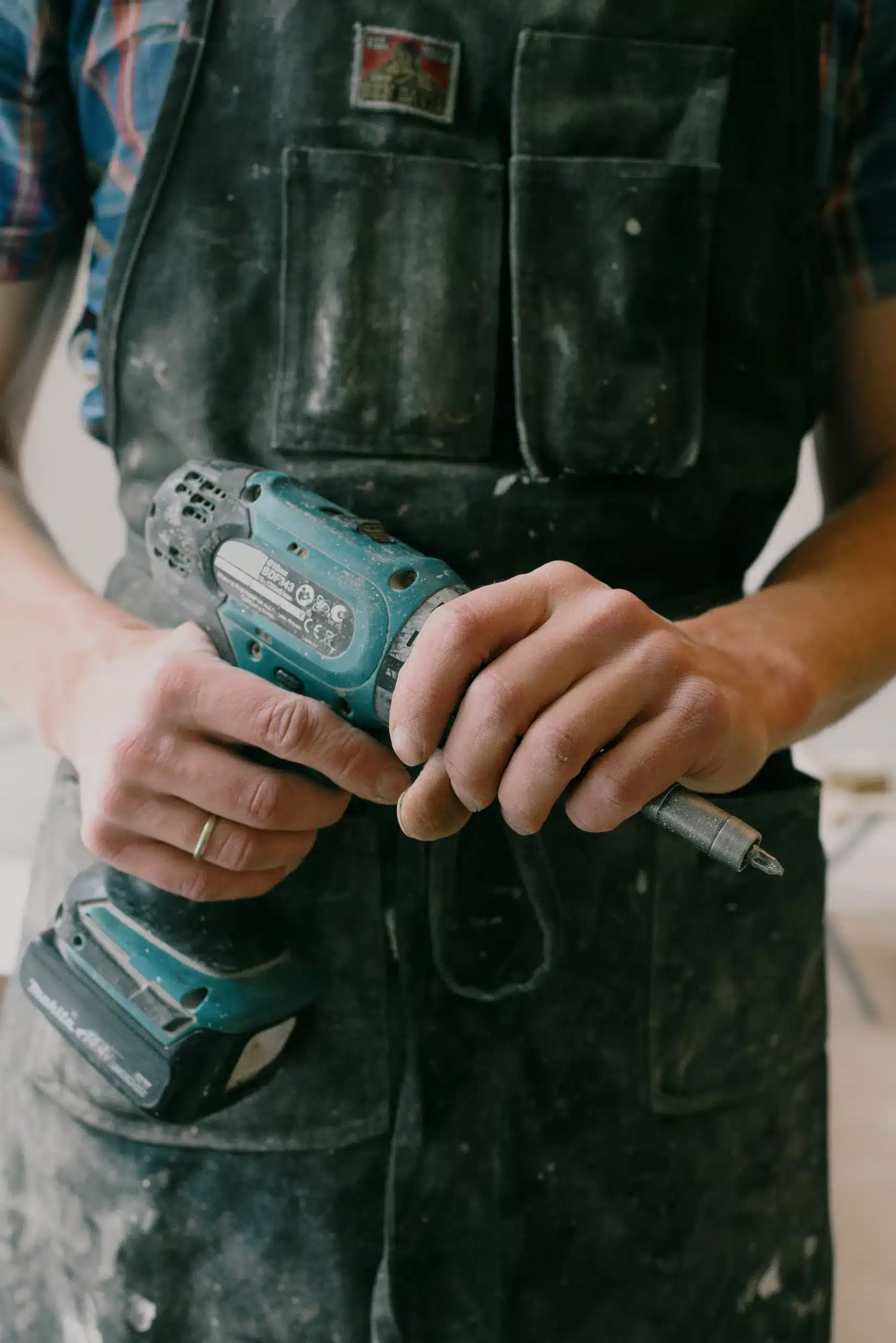 One Team Construction worker holding a drill during a Birmingham house renovation.